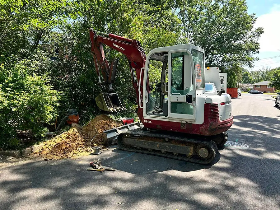 Excavation equipment on site for underground sewer line repair