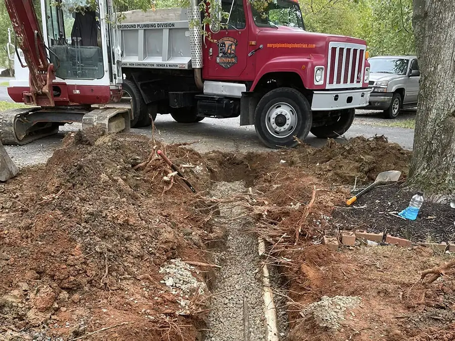 Open trench prepared for residential sewer pipe repair